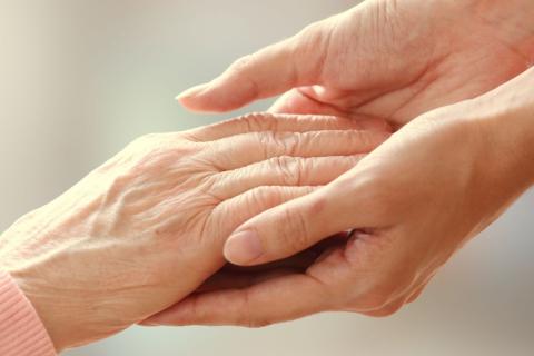 Two woman holding their hands