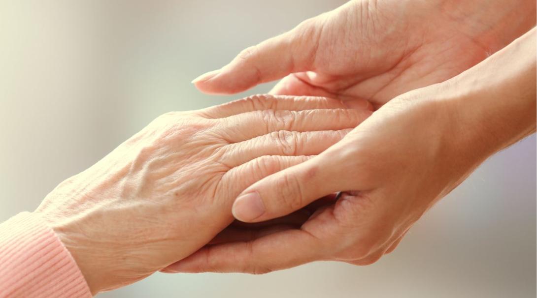 Two woman holding their hands